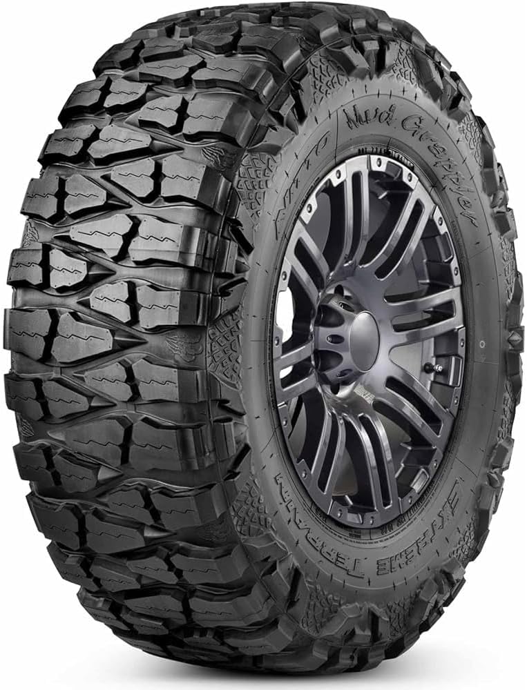 Nitto Mud Grappler extreme terrain tire, deep tread blocks wrapping over the shoulder into lizard-skin sidewall lugs